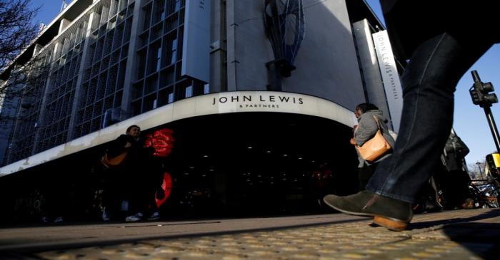 FILE PHOTO: Shoppers walk past the John Lewis department store on Oxford Street in London