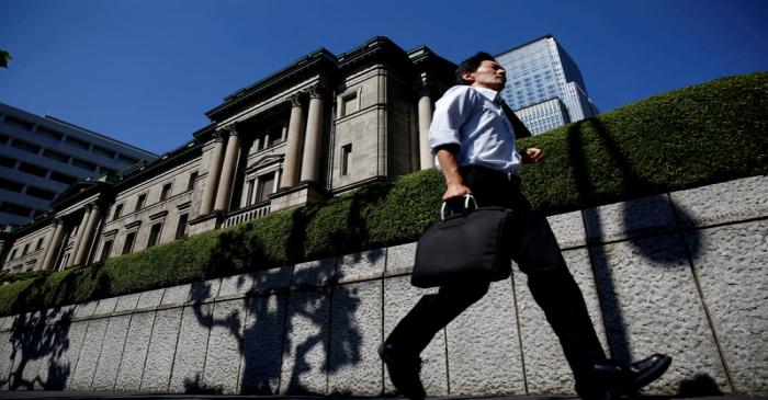 FILE PHOTO: A man runs past the Bank of Japan (BOJ) building in Tokyo