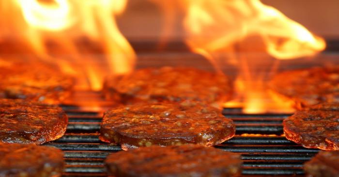 Veggie burgers are cooked over a flame on a grill in Greenwich, Connecticut