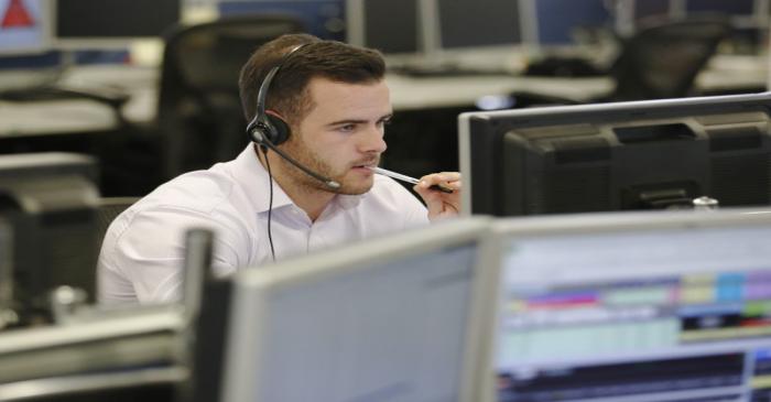 A trader sits at his desk at IG Index in London