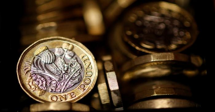 FILE PHOTO: Pound coins are seen in this photo illustration taken in Manchester, Britain