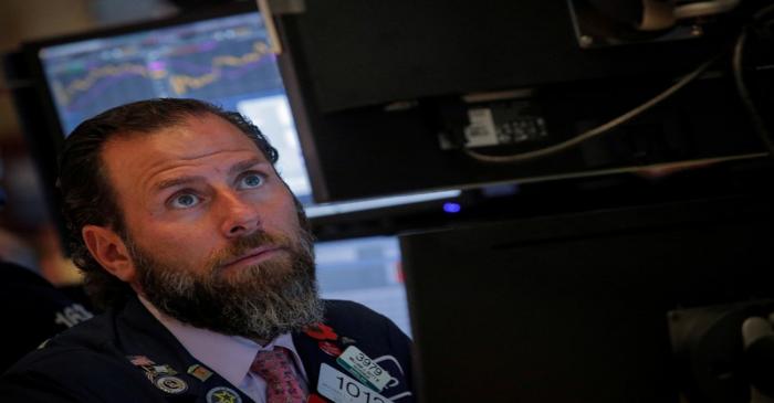 A trader works at his post on the floor at the NYSE in New York