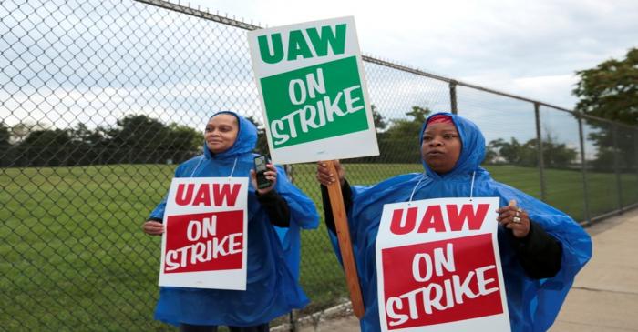 United Auto Workers, Aramark workers carry strike signs while picketing outside the General