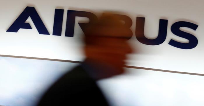 FILE PHOTO: A man walks past an Airbus logo at the Langkawi International Maritime and