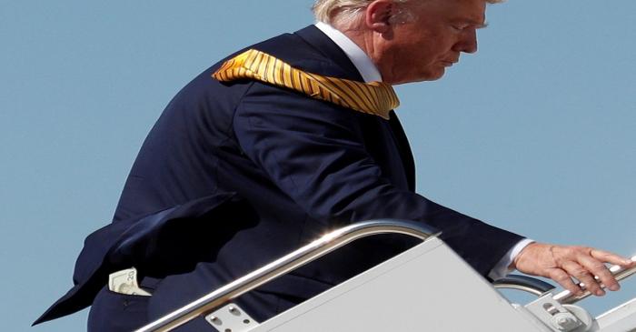 Money is seen in the back pocket of U.S. President Trump as he boards Air Force One at Moffett