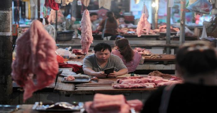 FILE PHOTO: Pork stalls at a market in Hekou, China