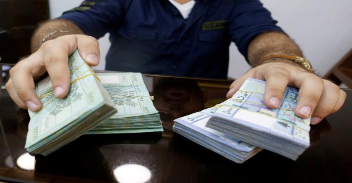 FILE PHOTO: A money exchange vendor displays Lebanese pound banknotes at his shop in Beirut