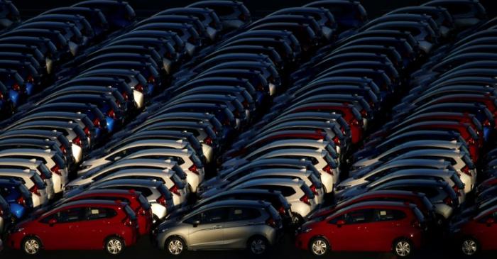 FILE PHOTO: Newly manufactured cars await export at port in Yokohama