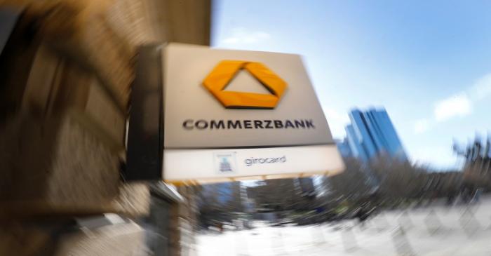 A sign for an ATM of Commerzbank is seen next to the headquarters of Deutsche Bank (R) in