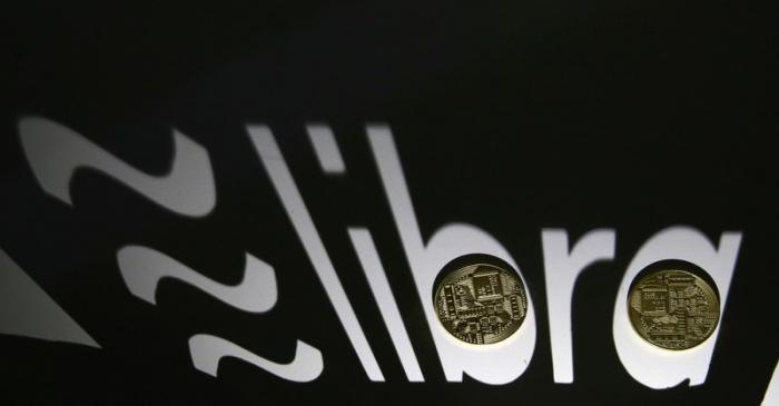 FILE PHOTO: FILE PHOTO: Shadow of a 3D-printed Facebook Libra cryptocurrency logo is seen near