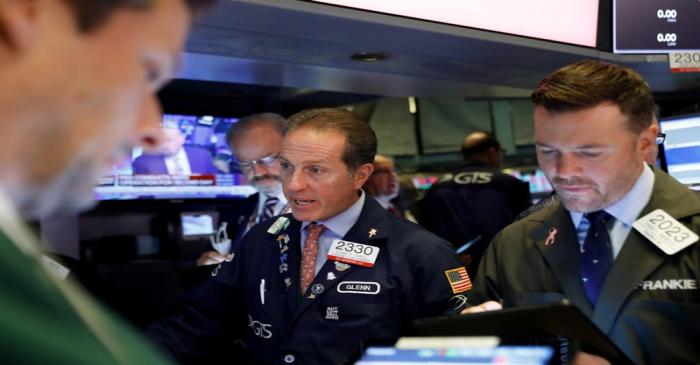 Traders work on the floor at the NYSE in New York