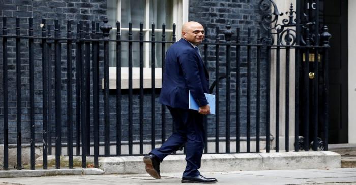 Britain's Chancellor of the Exchequer Sajid Javid walks outside Downing Street in London