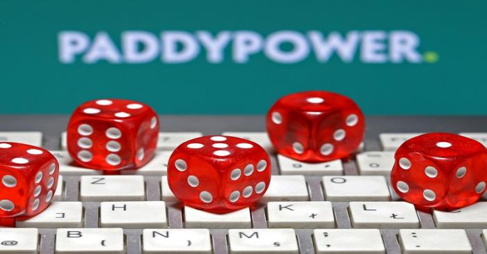 Paddy Power logo is seen behind a keyboard and gambling dice in this illustration taken in
