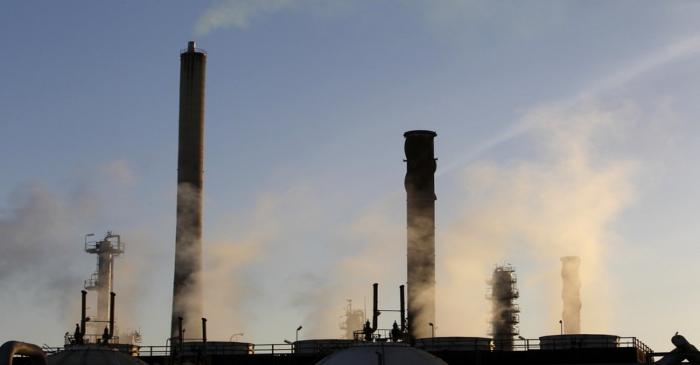 Steam is seen coming from the cooling towers at an oil refinery in Melbourne