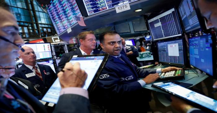 Traders work on the floor at the NYSE in New York
