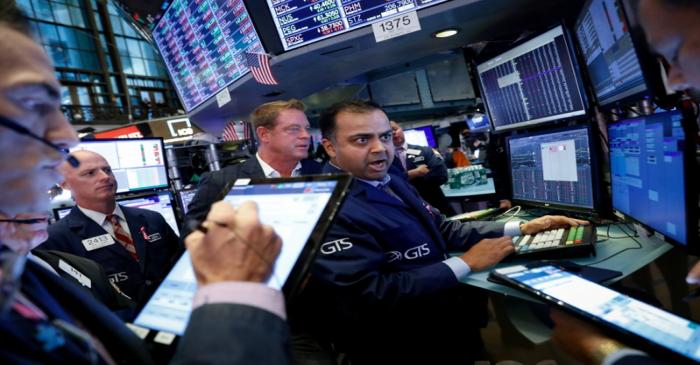 Traders work on the floor at the NYSE in New York