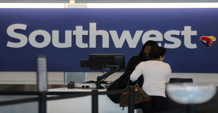 FILE PHOTO: A traveler checks her baggage at the Southwest Airlines terminal at LAX airport in