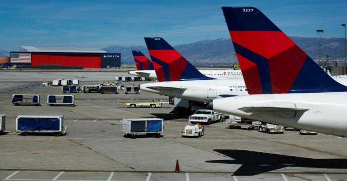 Delta planes line up at their gates while on the tarmac of Salt Lake City International Airport