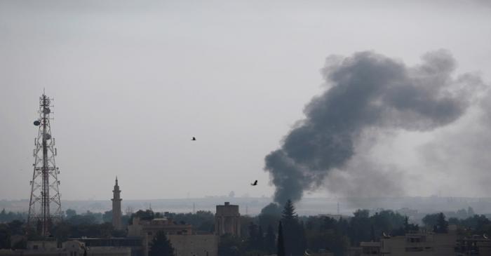 Smoke rises over the Syrian town of Ras al-Ain, as seen from the