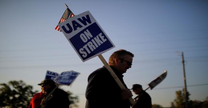 Striking union workers walk the picket line outside the GM Flint Truck Assembly in Flint