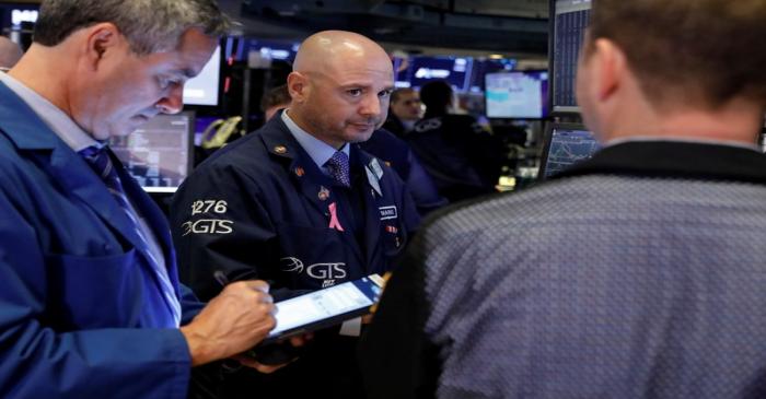 Traders work on the floor at the NYSE in New York