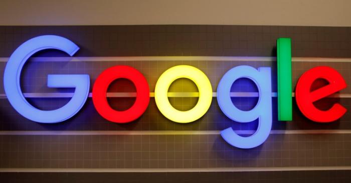 FILE PHOTO: An illuminated Google logo is seen inside an office building in Zurich