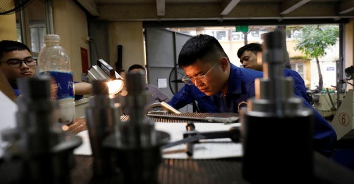 Students practise at a lab of an industrial vocational training college in Hanoi