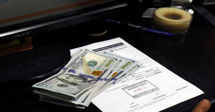 U.S. dollar notes are seen on a desk at a currency exchange booth in Karachi