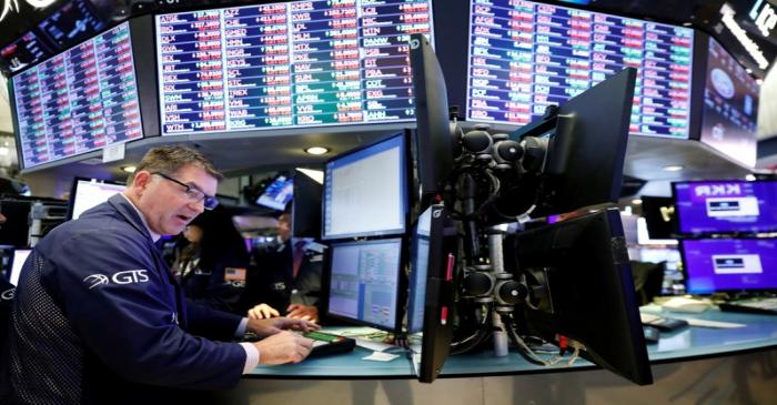 FILE PHOTO: A trader works on the floor of the New York Stock Exchange shortly after the