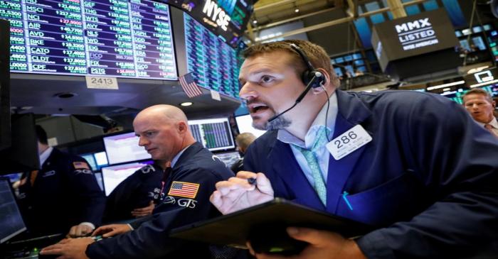 Traders work on the floor at the NYSE in New York