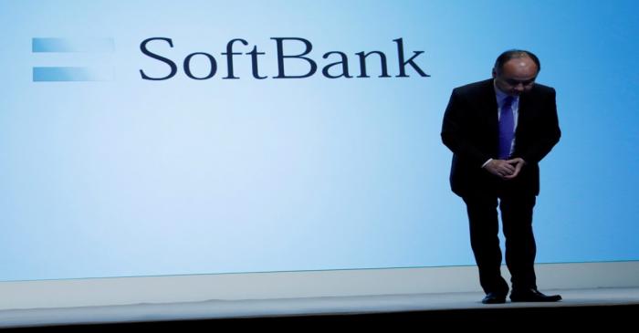 FILE PHOTO: Japan's SoftBank Group Corp Chief Executive Masayoshi Son bows his head after his