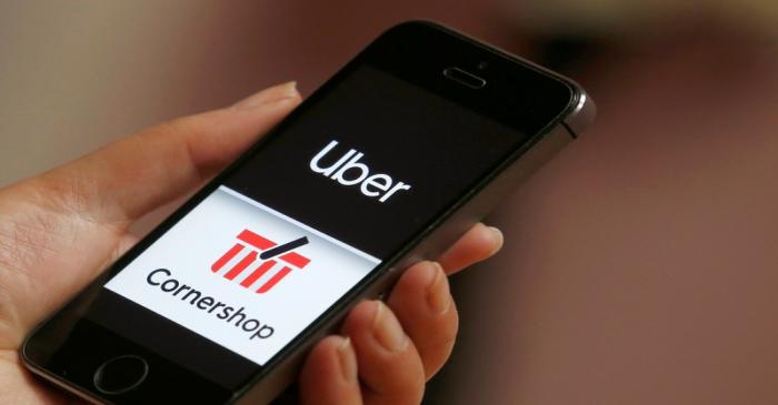 The logo of the Chilean online grocery provider Cornershop next to the logo of Uber application