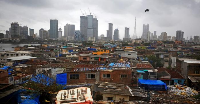 FILE PHOTO: Bird flies across central Mumbai's financial district skyline