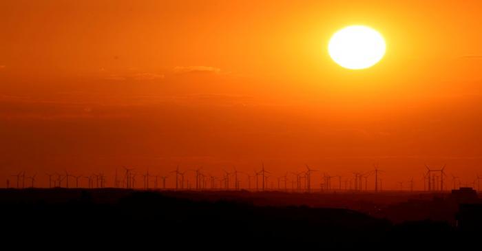 FILE PHOTO: Power-generating windmill turbines are pictured during sunset from the  Drachenberg