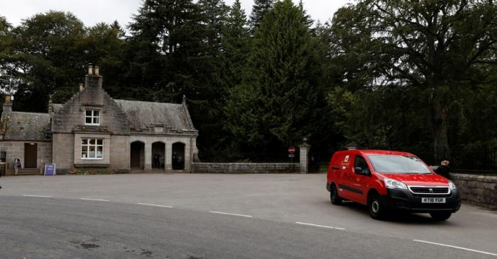 A Royal  Mail van leaves Balmoral Castle, Scotland