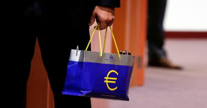 An official holds a bag with the euro logo during a eurozone finance ministers meeting in