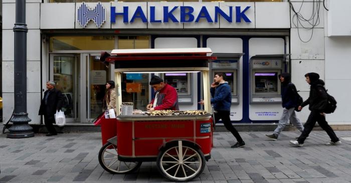 FILE PHOTO: A street vendor sells roasted chestnuts in front of a branch of Halkbank in central