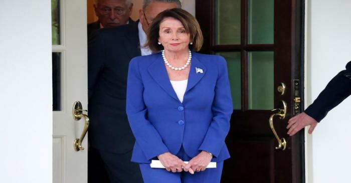 U.S. House Speaker Pelosi walks out with Senator Schumer and Rep. Hoyer after meeting with