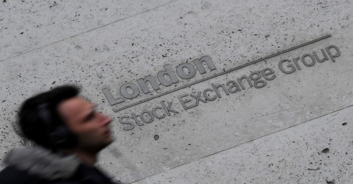 A man walks past the London Stock Exchange Group offices in the City of London, Britain