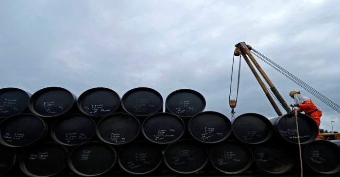 A worker prepares to transport oil pipelines to be laid for Pengerang Gas Pipeline Project in