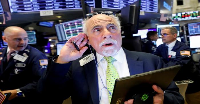 Traders work on the floor at the NYSE in New York