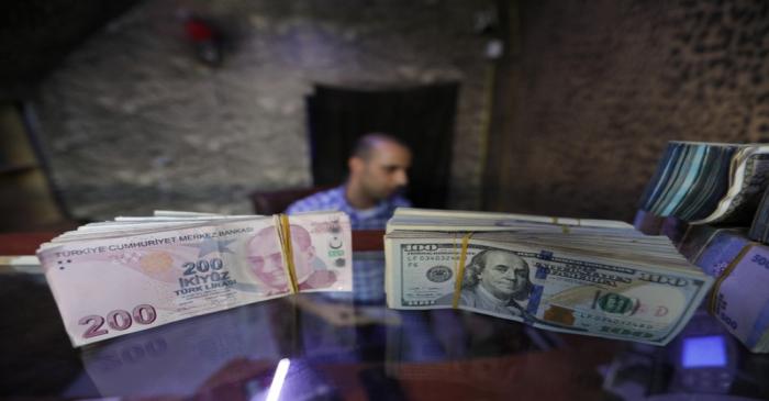 Banknotes of U.S. dollars and Turkish lira are seen in a currency exchange shop in the city of