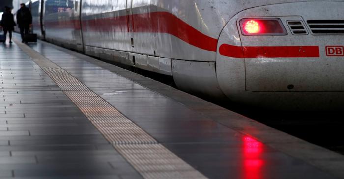 Passengers walk past a high speed ICE train of German railway Deutsche Bahn at the main train