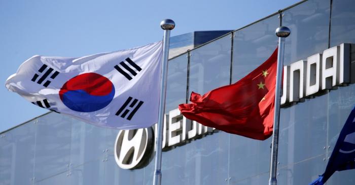 Flags of South Korea and China are seen at a plant of Hyundai Motor Co on the outskirts of