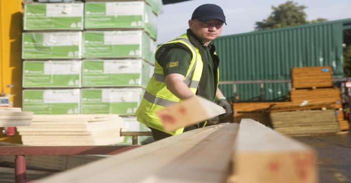 File photo of a worker stacking timber at the Vauxhall depot of building material supplier