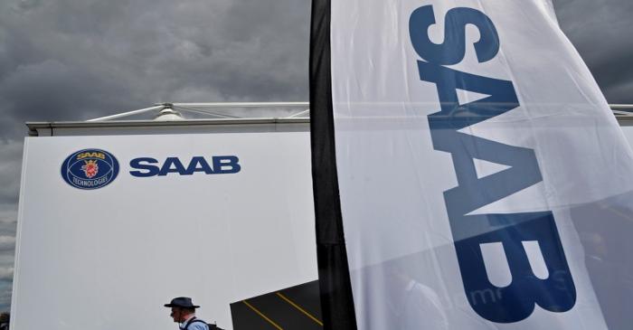 FILE PHOTO: A visitor walks past a Saab Technologies pavilion at Farnborough International