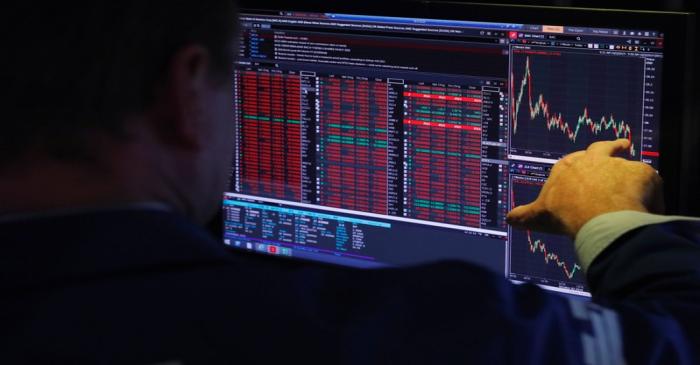 FILE PHOTO: A trader works on the floor of the New York Stock Exchange shortly after the