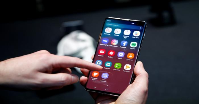 FILE PHOTO: A journalist uses the new Samsung Galaxy S10 smartphone at a press event in London