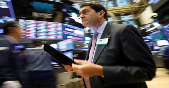 Traders work on the floor at the NYSE in New York