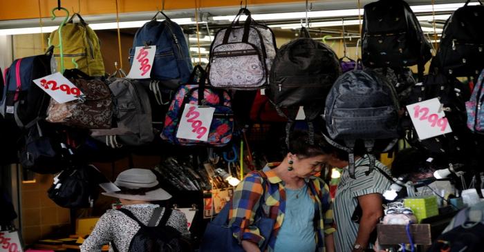 FILE PHOTO: Shoppers look around at goods in a shop in Tokyo